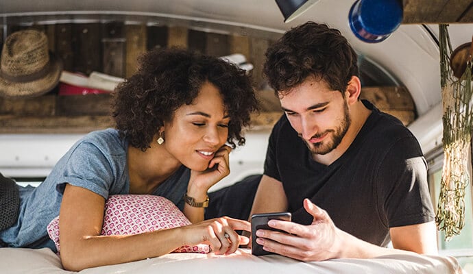 Hombre y mujer que miran un teléfono móvil